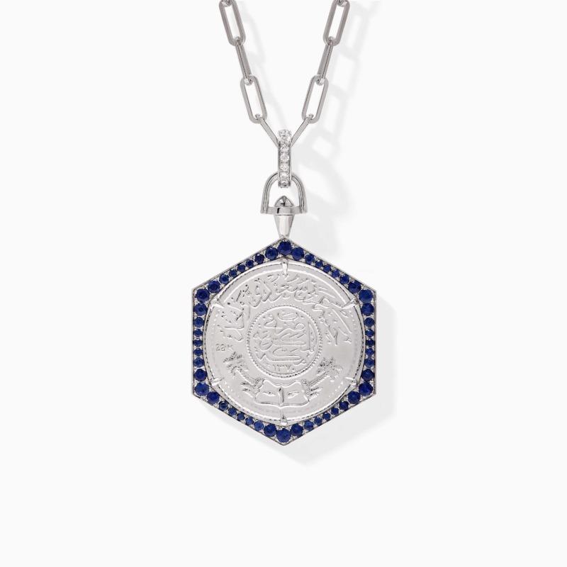 Elegant Ginea Necklace in Blue Sapphire Frame with diamond accents, blue sapphire stones, and a silver-tone bail and clasp.