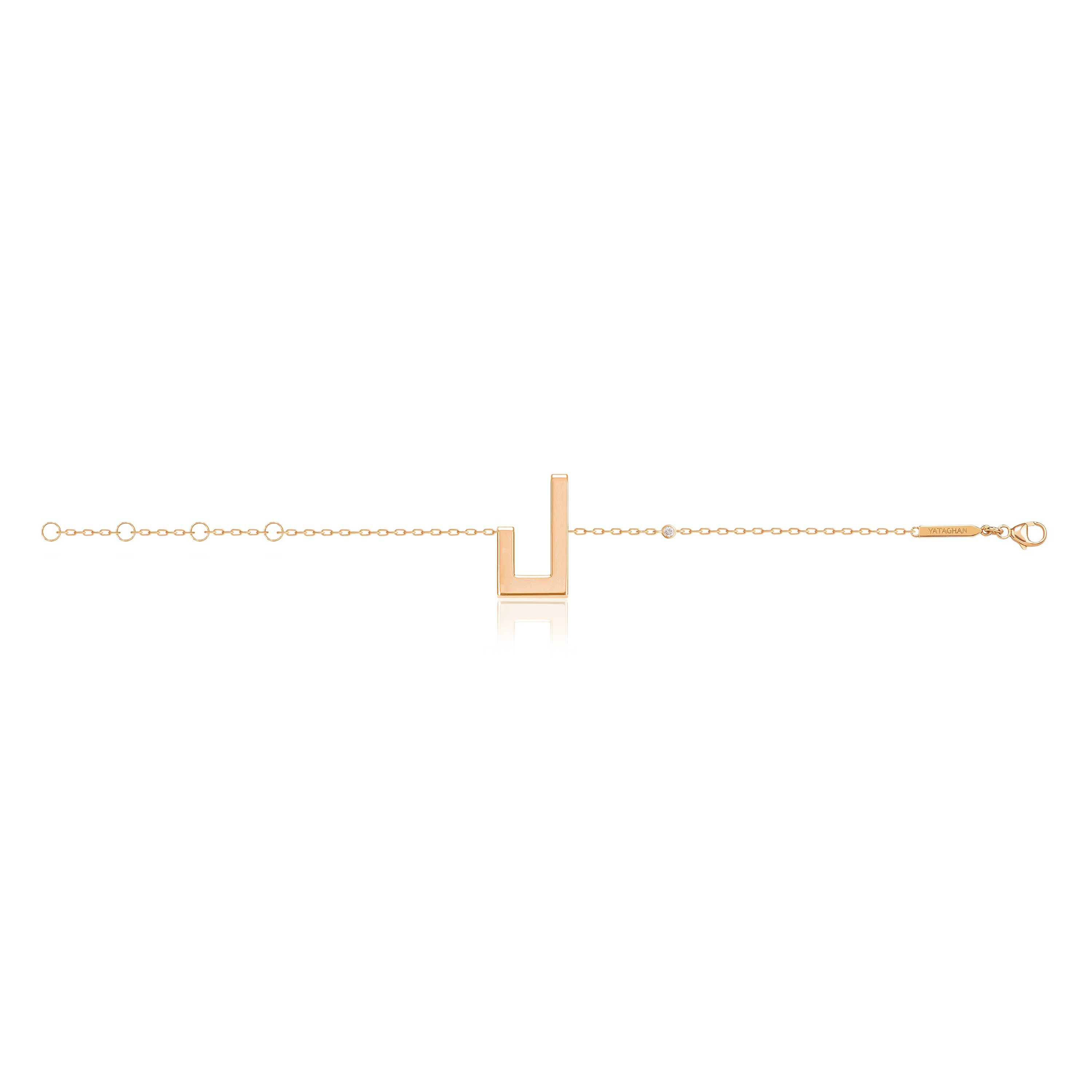 Delicate gold-tone Harfi Laam Bracelet with a slender chain and geometric U-shaped centerpiece on white
