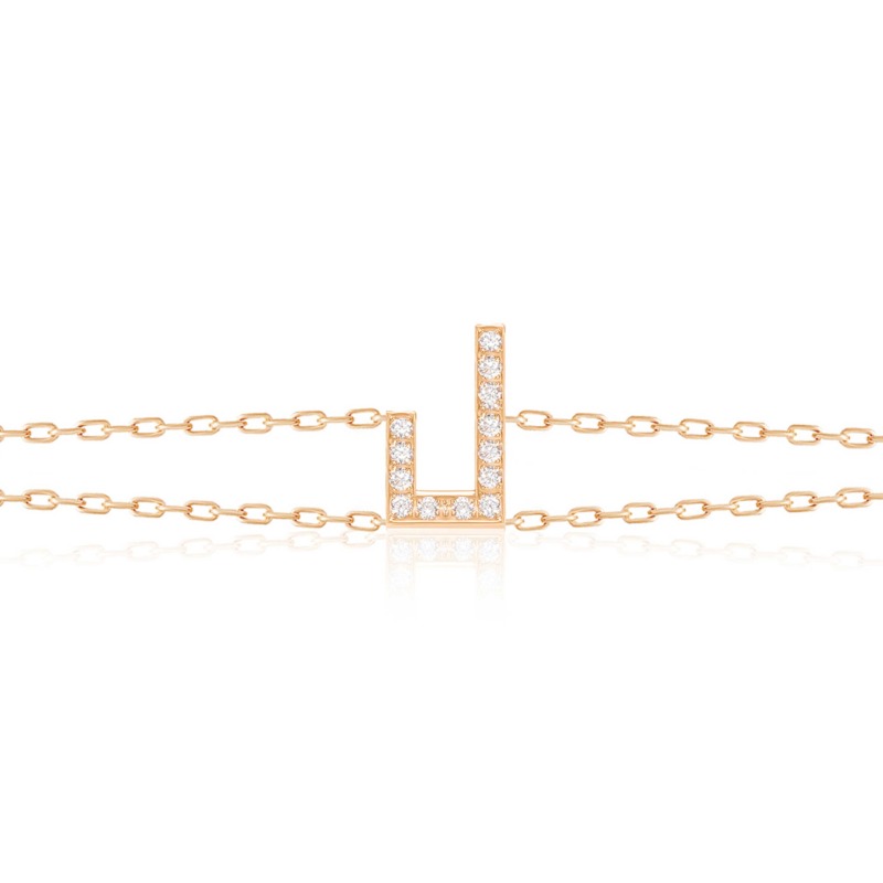 Delicate gold-tone Harfi Laam Bracelet with diamond-set Arabic letter detailing and fine chain links on a white surface.
