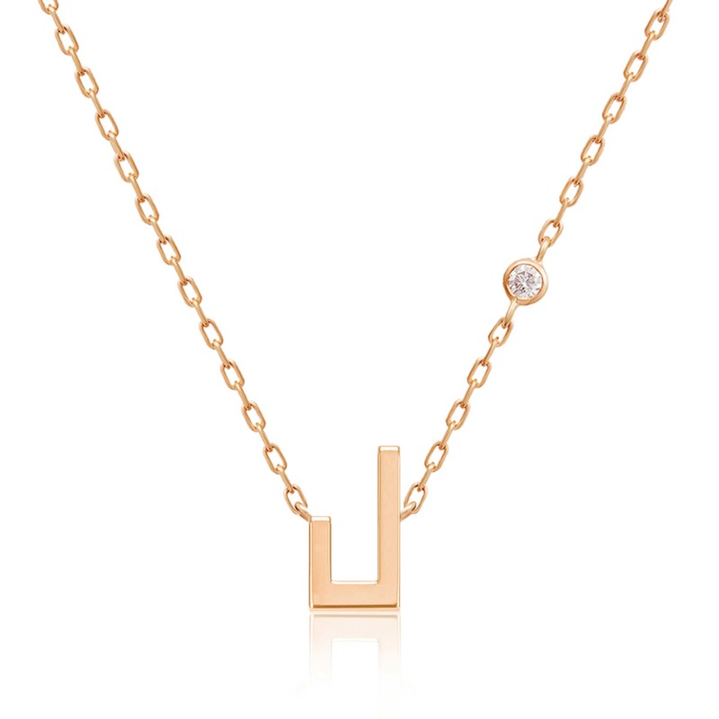 Gold-tone Harfi Laam necklace with a geometric pendant, linked chain, and round gemstone accent on a white background.