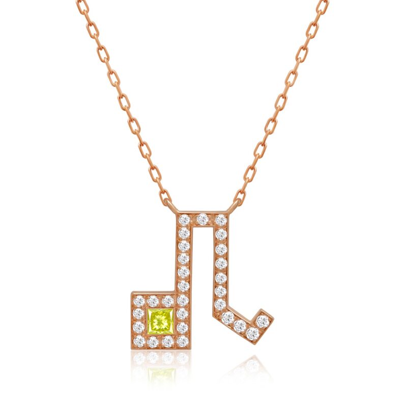 A Leo horoscope necklace with a rose-gold pendant set in yellow-green gemstone and round pavé stones on a delicate chain.