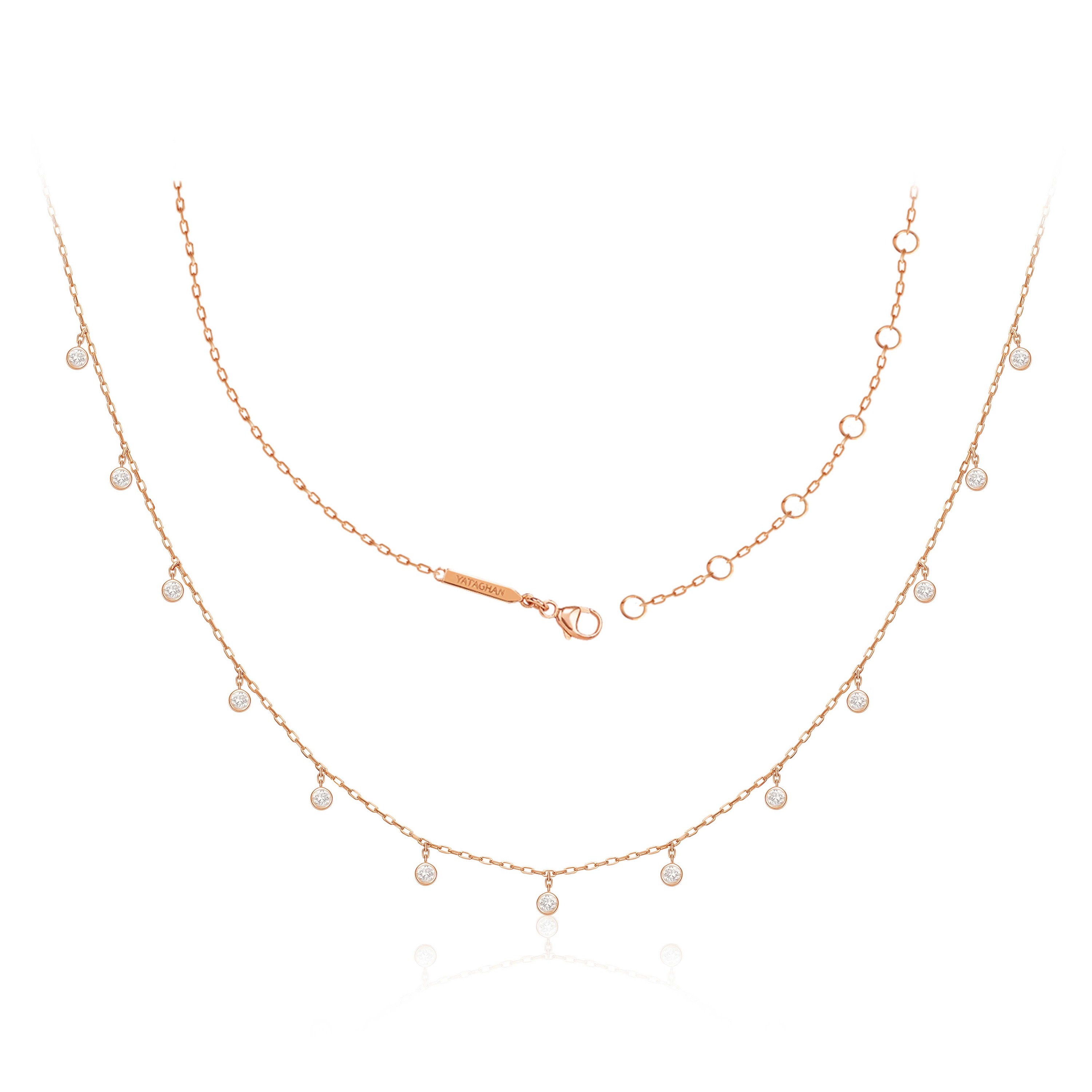 A rose gold Sparkle Round Necklace from Yataghan Jewellery shows layered chains with bezel-set clear stones and a delicate branded clasp.