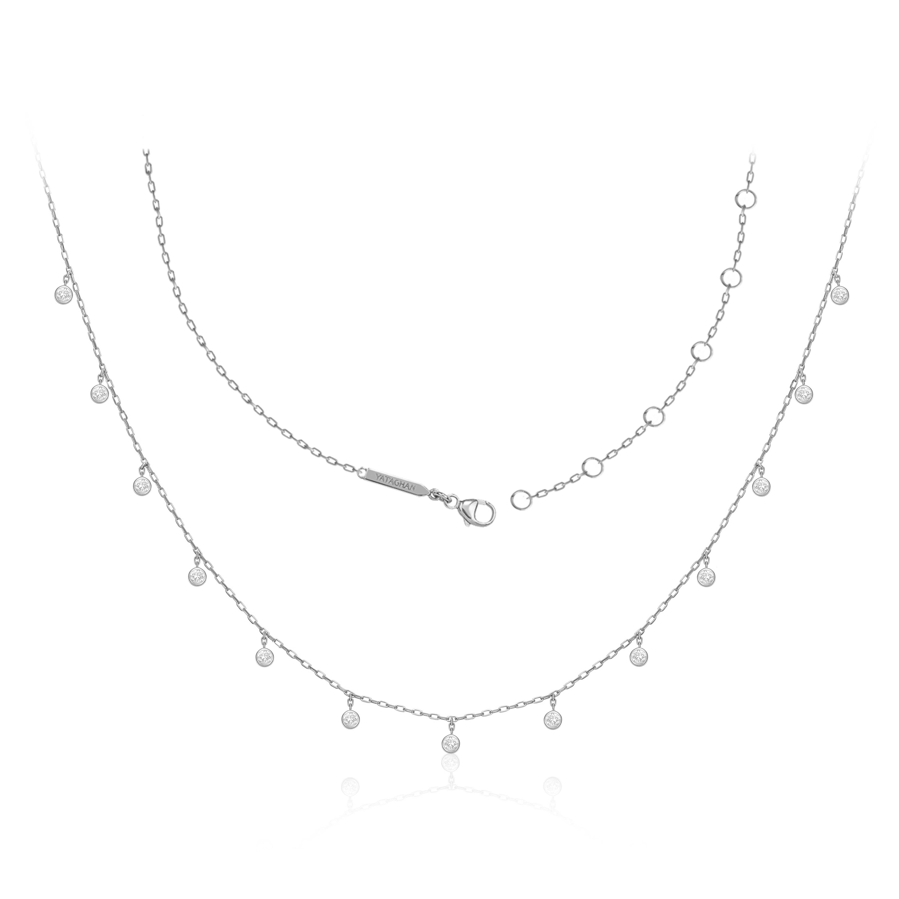 A delicate silver Sparkle Round Necklace from Yataghan Jewellery shows layered chains with round crystal charms and a central YATAGHAN clasp.