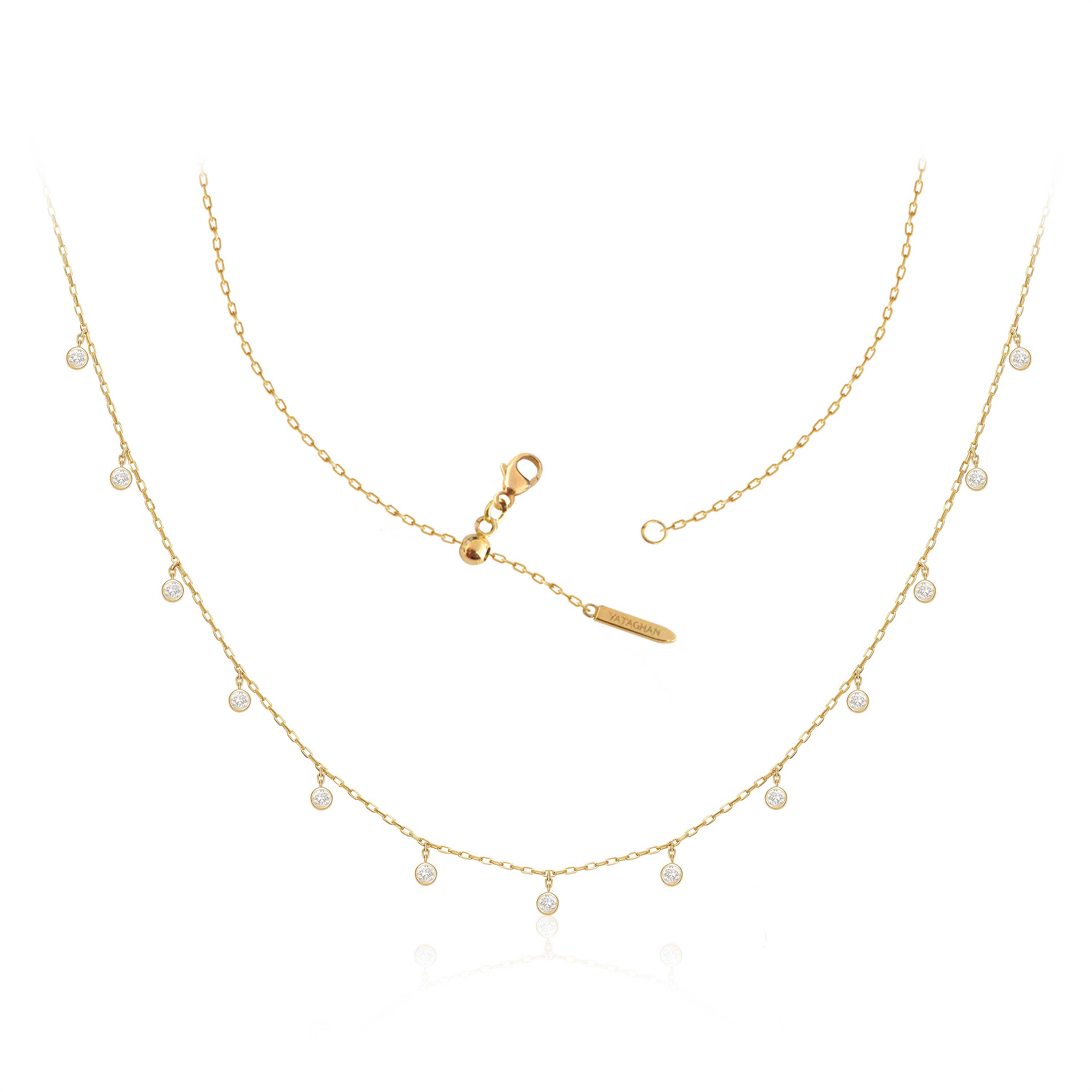 A delicate golden Sparkle Round Necklace from Yataghan Jewellery with tiny round drops and a branded clasp on a white background.