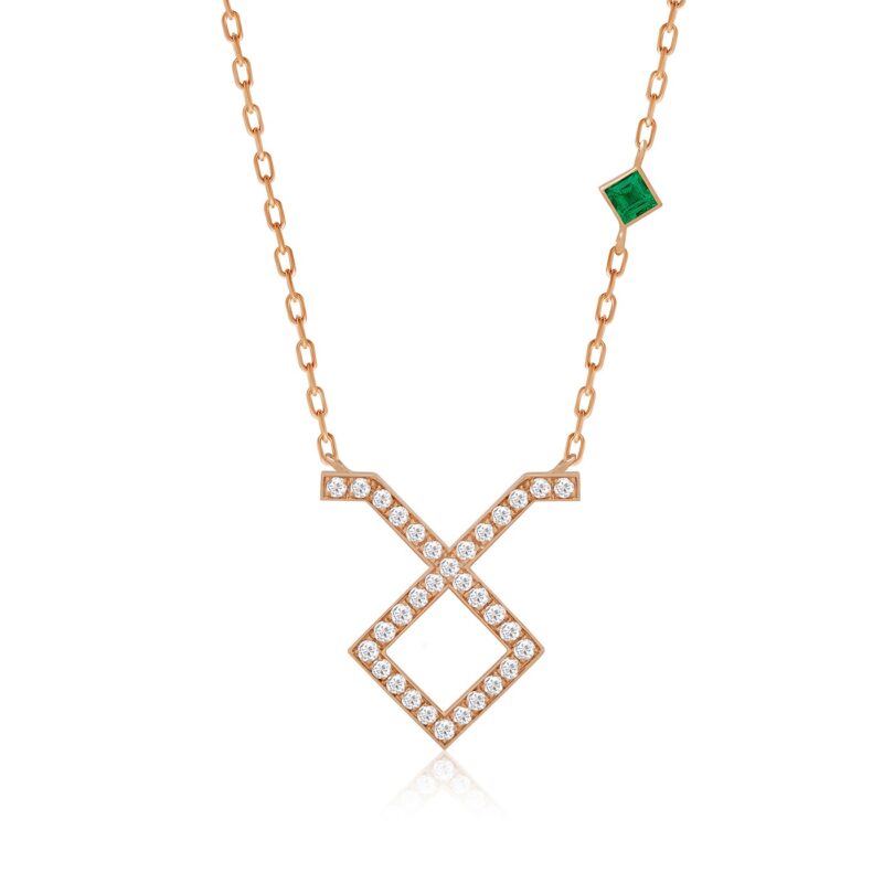 Taurus horoscope necklace with an emerald-green square centerpiece, rose gold chain and X motif set with sparkling stones and links.