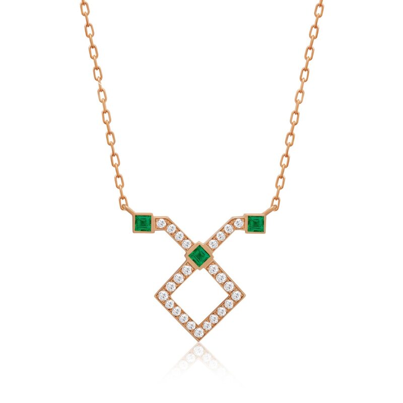 Rose gold horoscope necklace for Taurus with emerald green stones and diamond accents in a geometric cross-and-diamond pattern.