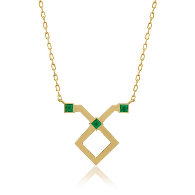 Gold horoscope necklace with a Taurus pendant, emerald-cut green stones and a geometric diamond centerpiece on a fine chain.