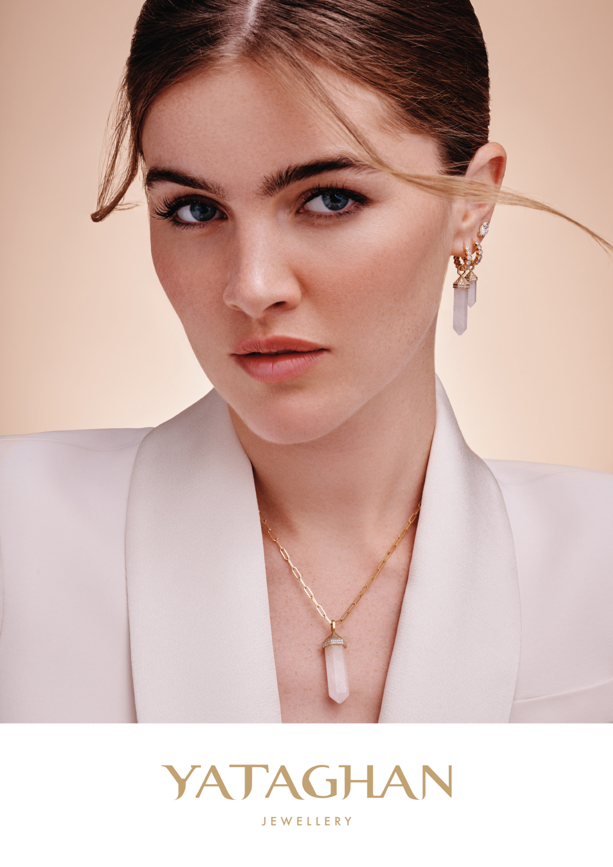 A close-up portrait of a model wearing Yataghan Jewellery crystal drop earrings and a pendant necklace for the 2026 VOGUE Arabia cover.