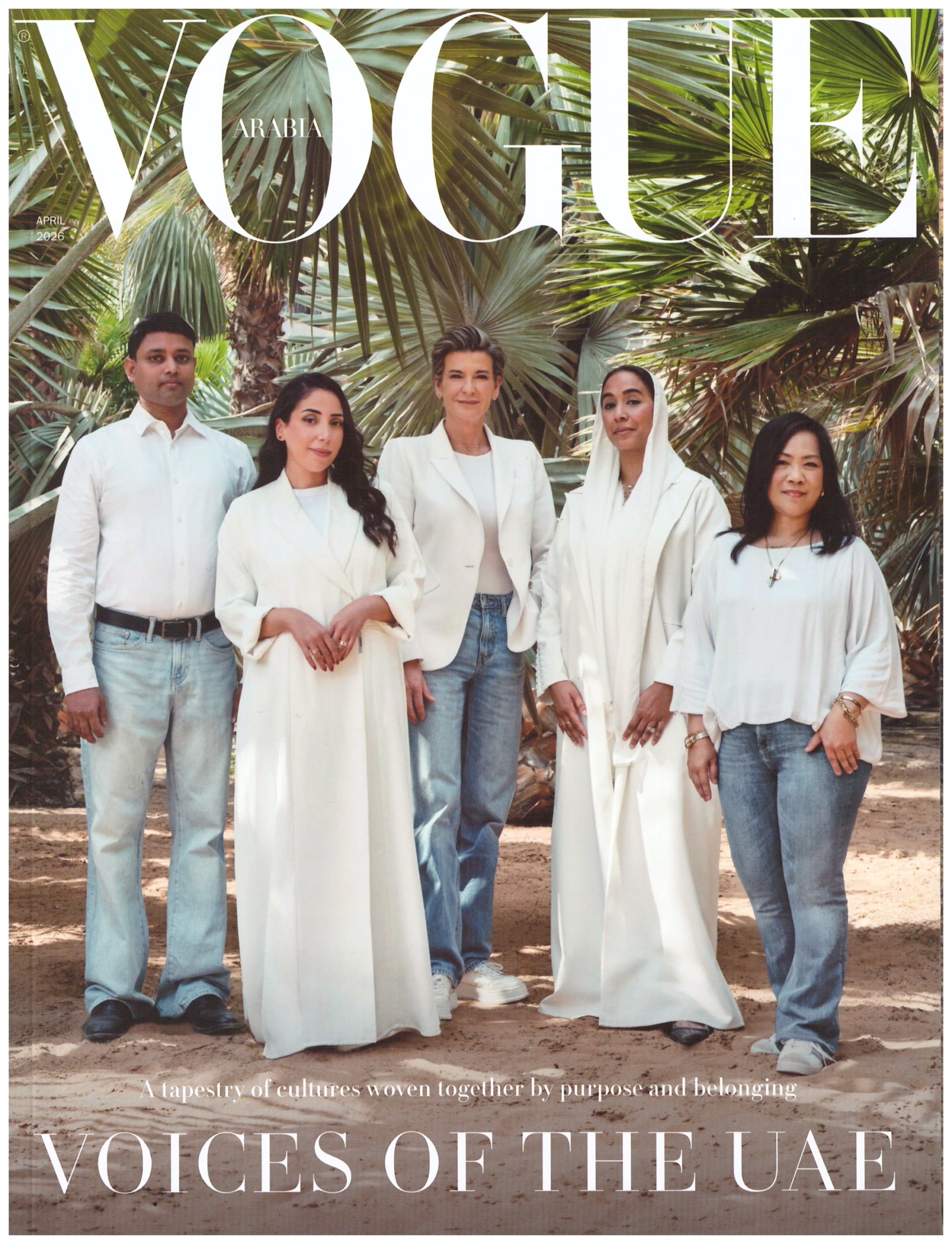 Five UAE voices stand in white outfits beneath palm fronds on the VOGUE Arabia April 2026 cover, with the title Voices of the UAE.