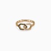 A gold Yataghan Jewellery ring with black enamel links and diamond-studded infinity shapes stands against a clean white background.