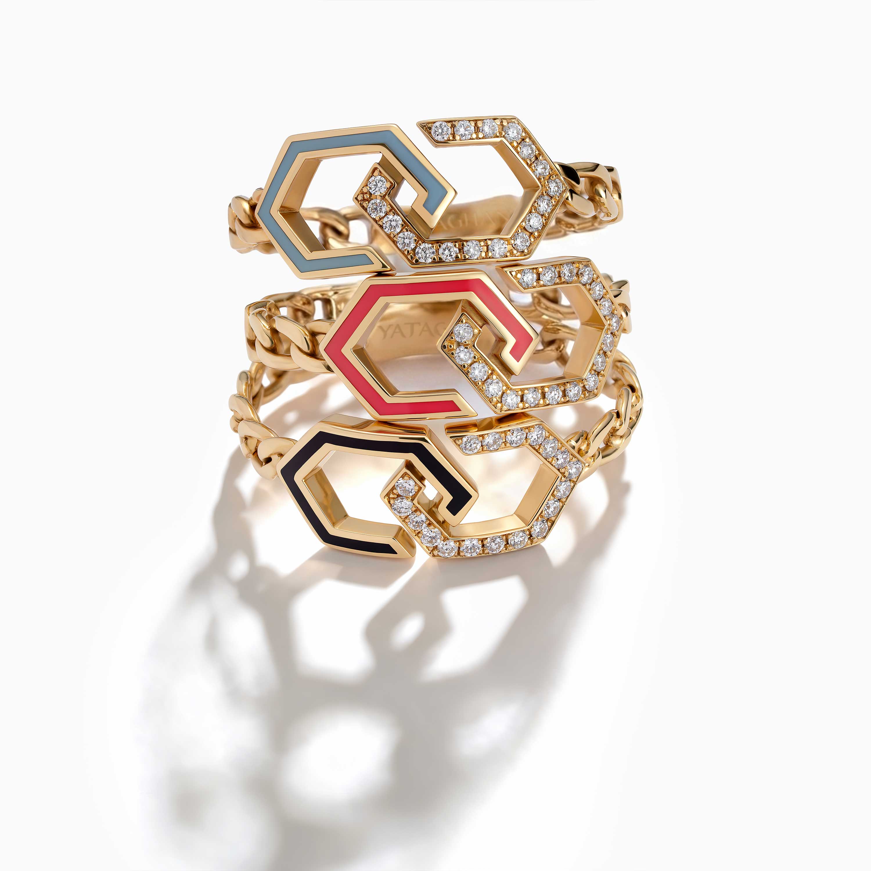 A gold Infinity Enamel Unchained Diamond Ring from Yataghan Jewellery shows interlocking enamel links with diamond accents in blue, pink and black.