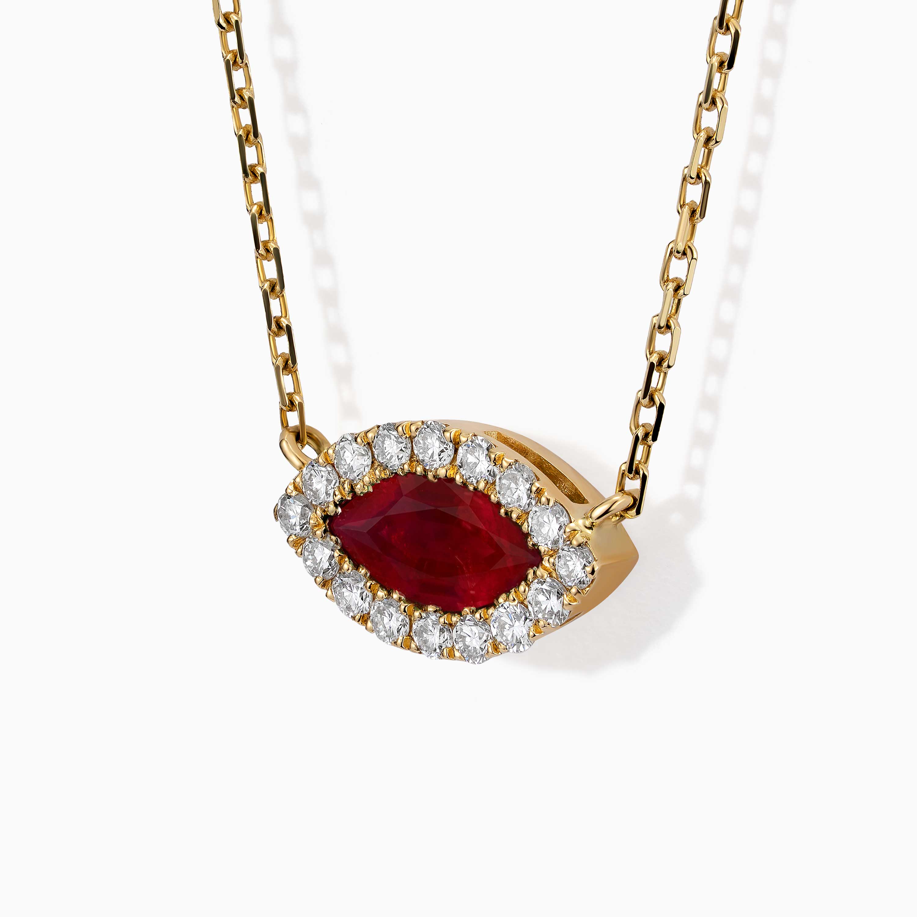 A marquise ruby pendant framed by diamonds hangs from a gold chain in The Eye necklace by Yataghan Jewellery.