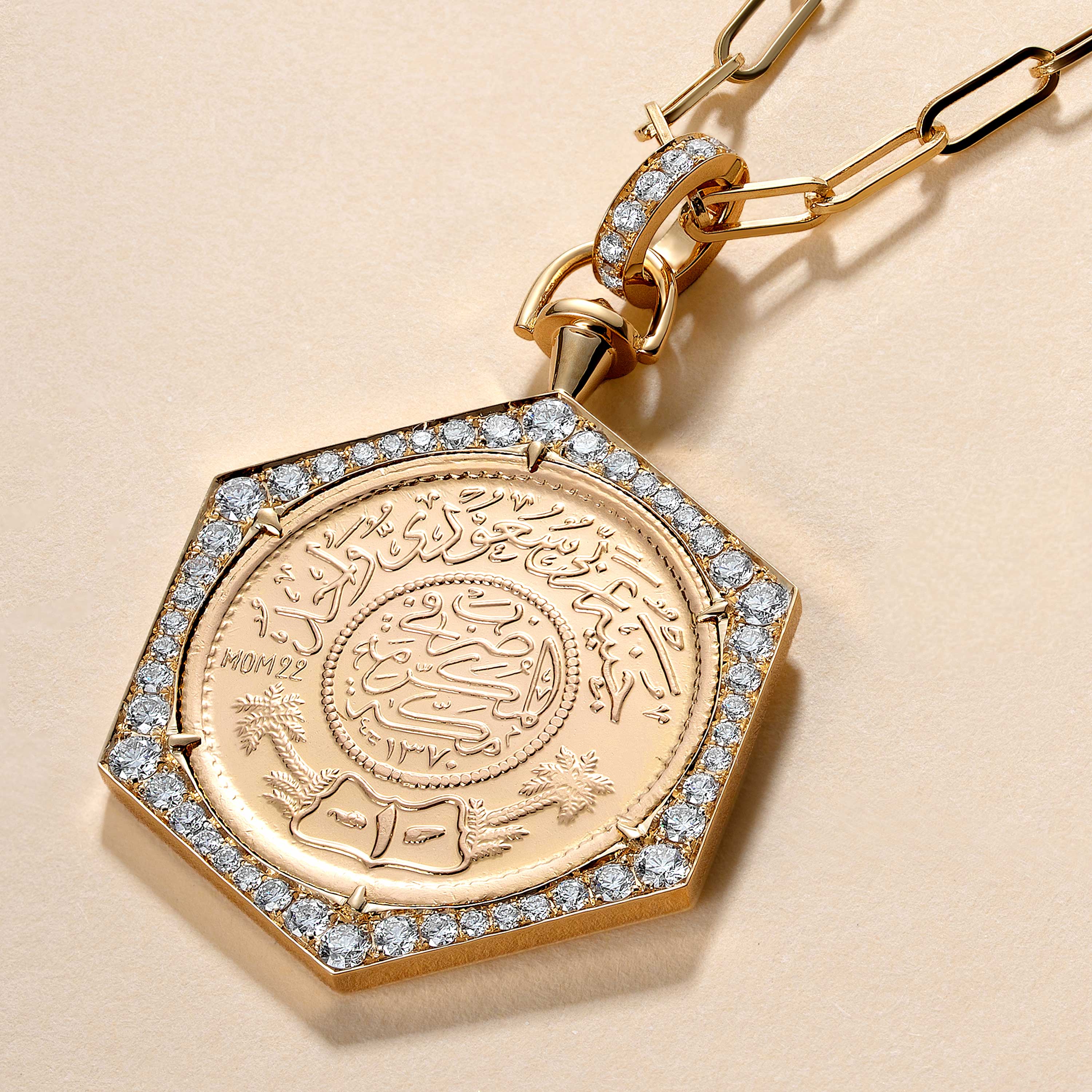 A Full Ginea Necklace in Diamonds with a gold bail and clasp, featuring a detailed engraved centerpiece and a border of diamonds.