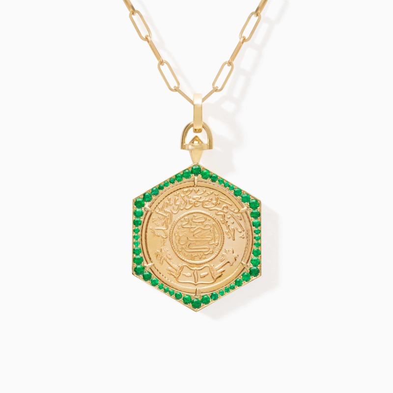 Ginea Necklace with emeralds and gold bail & clasp, showing an engraved pendant border with emerald green stones and gold detailing.