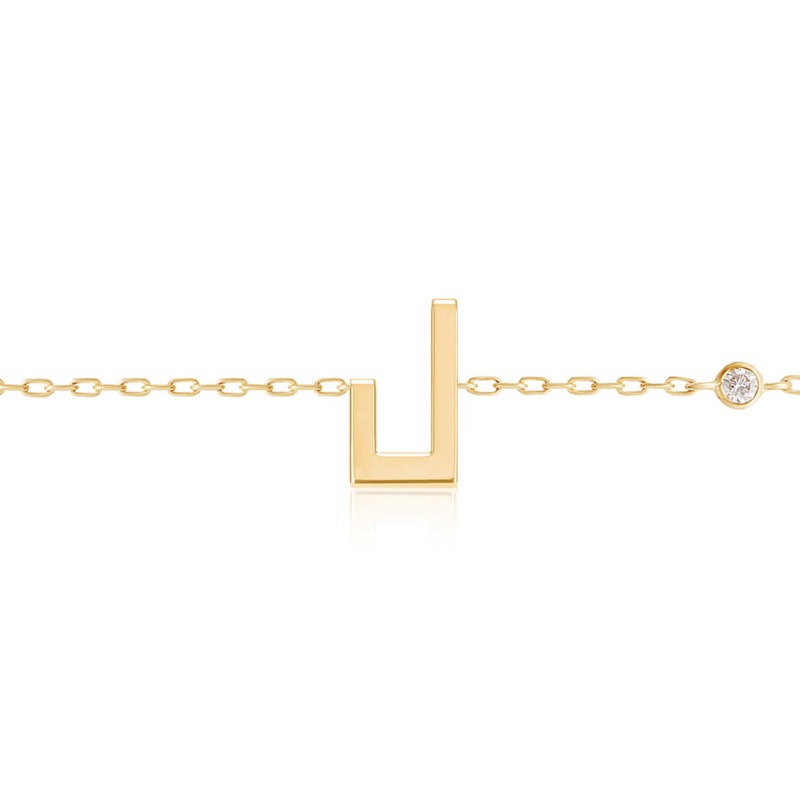 Gold-tone Harfi Laam Bracelet with a U-shaped pendant and a round diamond detail on a fine chain