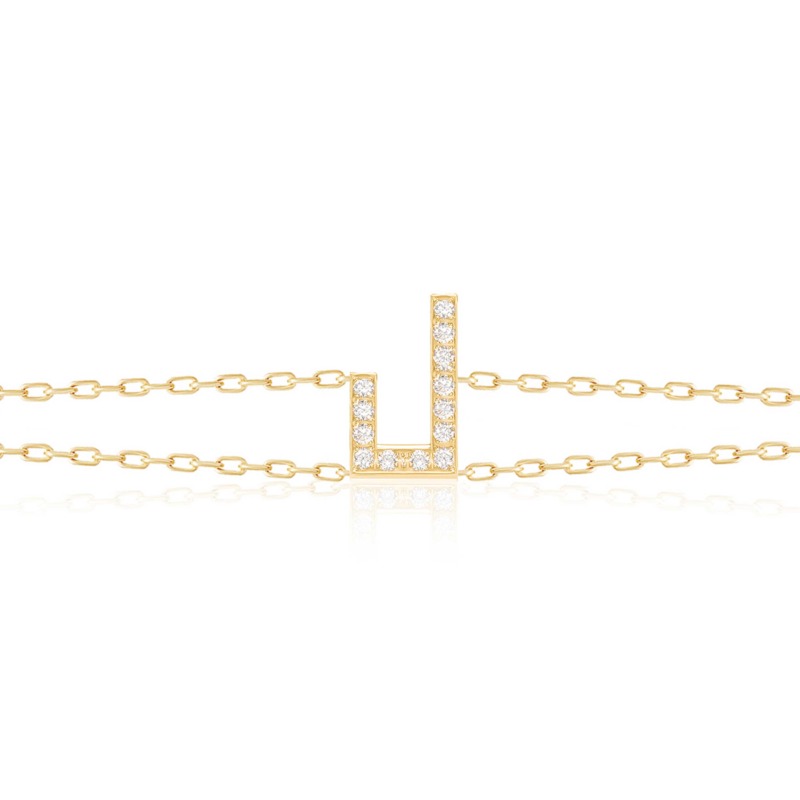 Gold-tone Harfi Laam Bracelet with diamond-set Arabic letter pendant and delicate chain links displayed against white