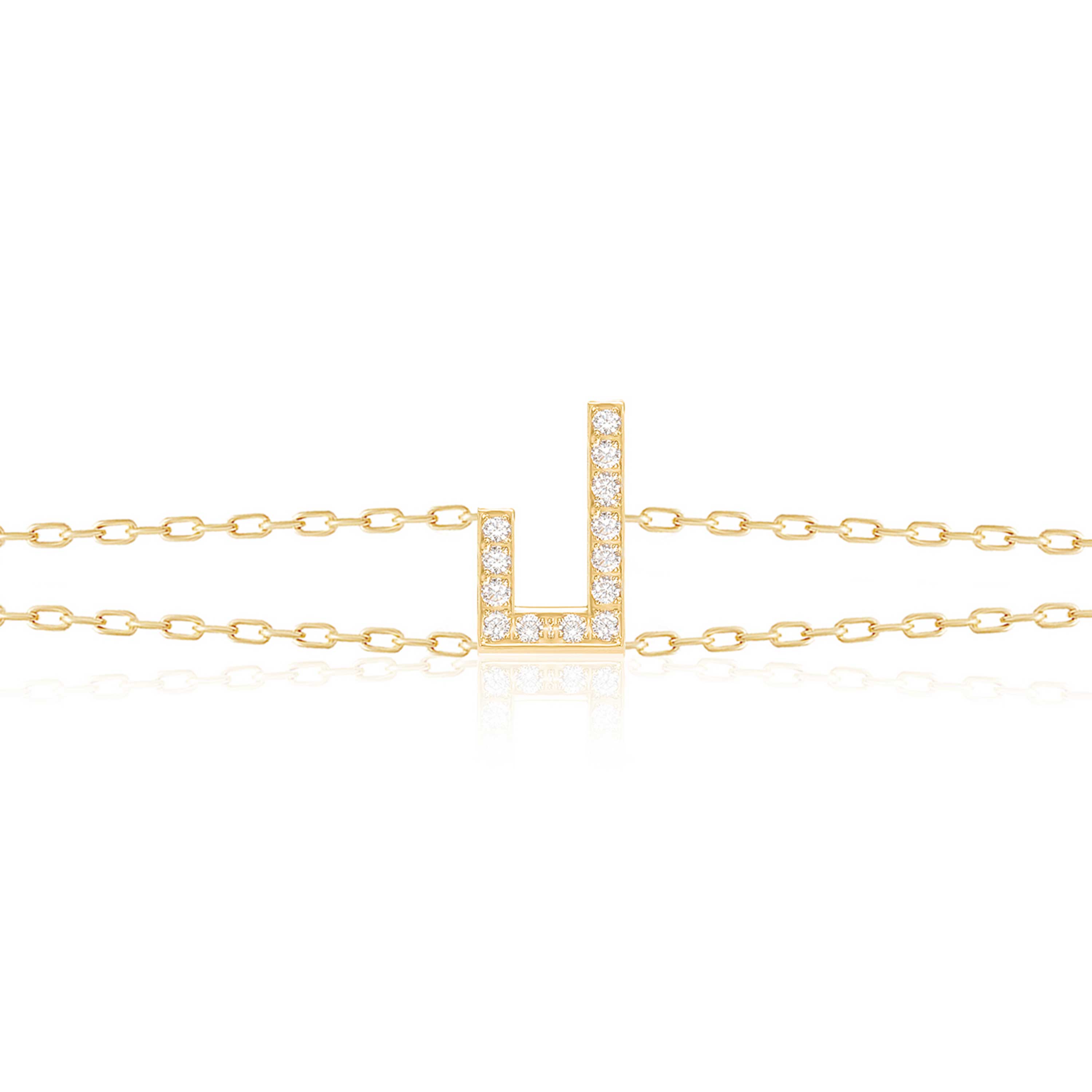 Gold-tone Harfi Laam Bracelet with diamond-set Arabic letter pendant and delicate chain links displayed against white