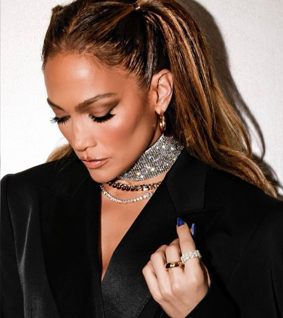 Jennifer Lopez wears Yataghan Jewellery with sparkling silver necklace, matching hoop earrings, and a statement ring, styled with a black outfit.