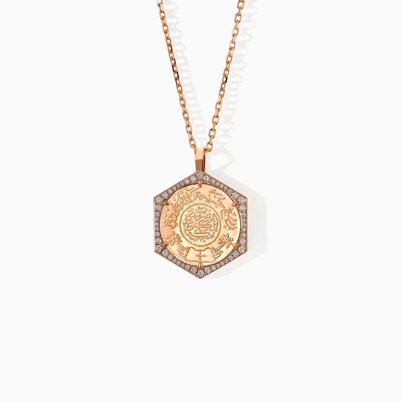 Gold Ginea Necklace with a diamond frame pendant and Arabic calligraphy medallion, set on a chain with a polished finish.