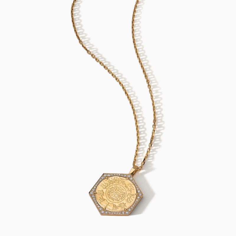 Gold-toned chain necklace with a hexagonal Ginea pendant in a diamond frame, from Quarter Ginea Necklace in Diamond Frame.