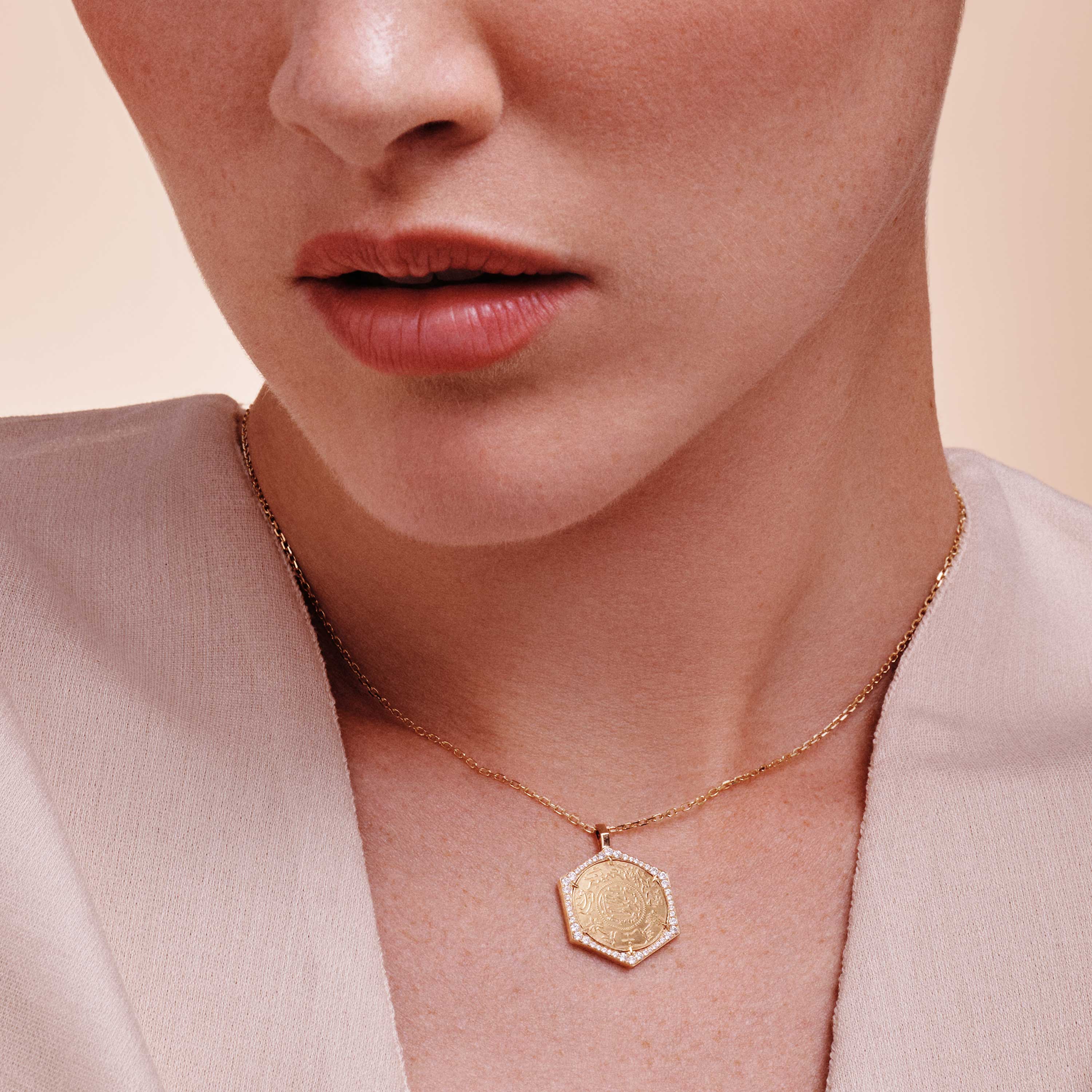 Quarter Ginea Necklace in Diamond Frame by Yataghan Jewellery with gold chain and diamond-framed pendant against a soft neutral background