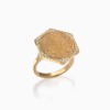 A gold Ginea Ring by Yataghan Jewellery with an engraved coin motif, set in a diamond frame and secure prong border.