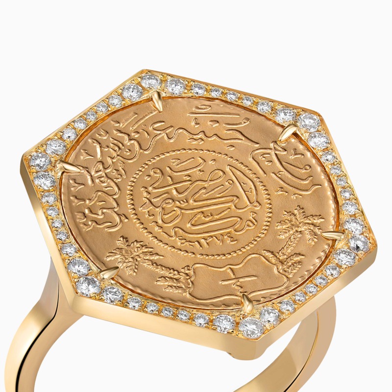 Close-up of Quarter Ginea Ring in Diamond Frame by Yataghan Jewellery in warm gold with engraved motif and round-cut diamonds along the band.
