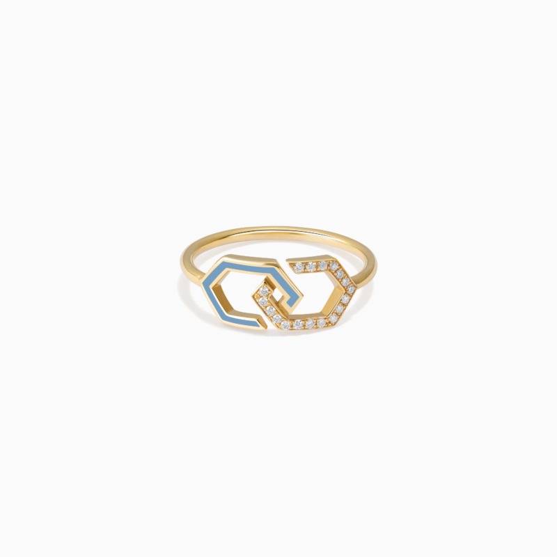 A gold Infinity Enamel Diamond Ring Band with blue enamel and diamond pavé details rests against a clean white background in a refined studio view.