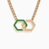 Interlocking gold infinity links form a pendant with light green enamel accents, suspended from a polished chain on a clean white background.