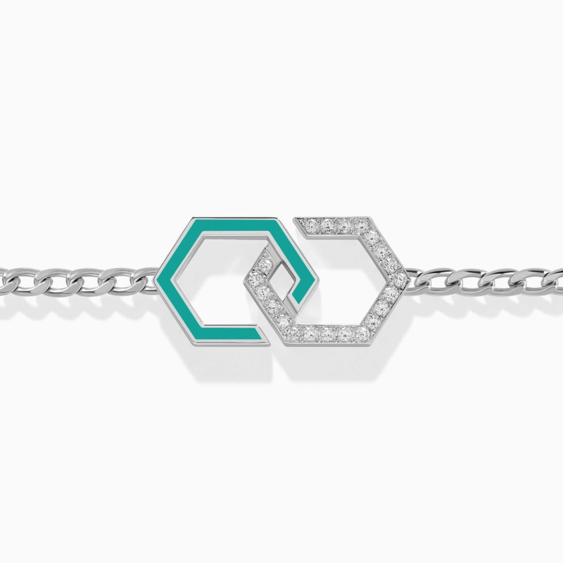 A silver chain bracelet displays interlocking hexagonal Infinity motifs, one outlined in turquoise enamel and the other paved with diamonds.