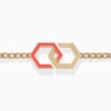 Gold bracelet with interlocking hexagonal links and red enamel accents rests against a clean white background, creating a bold infinity-inspired design.