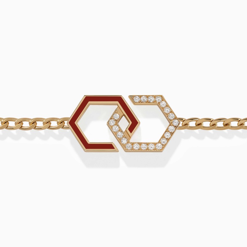A gold Infinity Enamel Unchained Diamond Bracelet with red enamel hexagon links and pavé diamonds rests on a clean white background.
