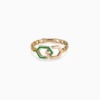 A gold chain ring with interlocking infinity links and green enamel accents rests on a white background, with YATAGHAN engraved on the clasp.