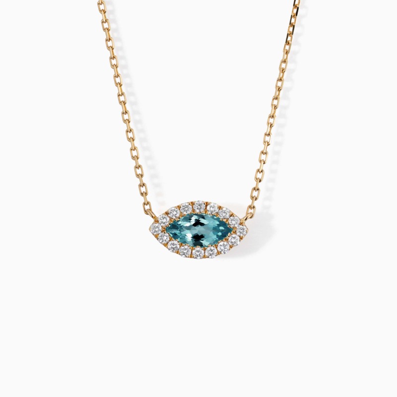 A marquise blue topaz pendant framed by diamonds hangs from a gold chain on a white background.