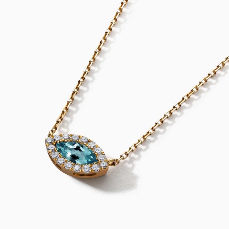 The Eye Marquise Emerald with Diamonds Necklace shows a gold chain and a marquise-cut blue-green emerald bordered by diamonds.
