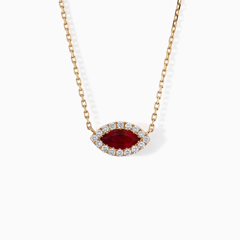 A gold chain necklace from The Eye features a marquise red ruby center framed by sparkling diamonds.